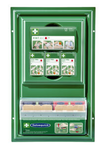 Green first aid station with compartments containing Salvequick plasters and boxes labeled "4-in-1 Mini" with illustrated instructions for wound care.